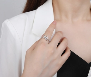 Detail of leaf-shaped silver ring with sparkling cubic zirconia on a model's finger