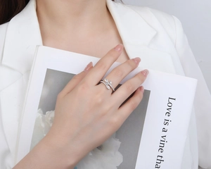 Close-up of S925 silver olive branch ring with zircon leaves on model hand