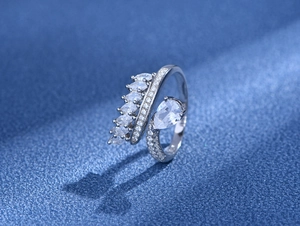 Macro shot of 925 silver bypass ring featuring marquise zircon leaves and pear main stone