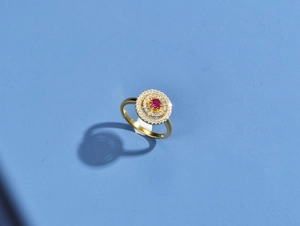 Top view of hollow round 925 silver ring with ruby center and shimmering pavé zircons