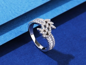 Macro shot of 925 silver leaf ring with pavé diamonds on a geometric blue background