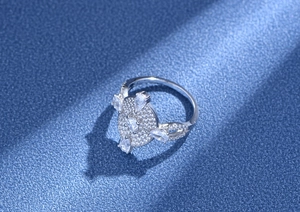 Macro view of S925 silver oval ring with pavé diamonds and teardrop gemstones
