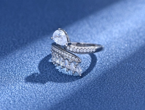 Macro shot of a 925 silver feather ring featuring a teardrop diamond and marquise accents