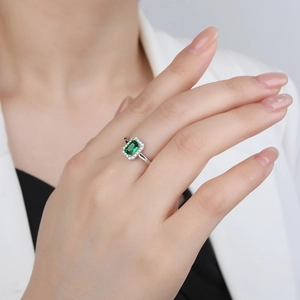 S925 silver ring featuring a rectangular emerald zircon with a halo setting on a model