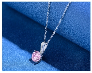 Macro shot of 7mm pink round-cut sparkling gemstone pendant on S925 silver chain