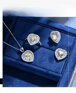 Detail of a 925 silver jewelry set featuring yellow heart-shaped gems in a blue velvet box