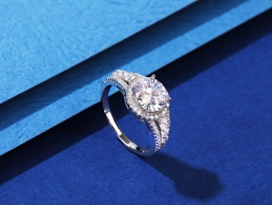 Macro detail of round 8mm halo engagement ring with split shank and marquise stones