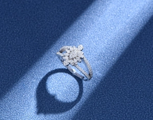 Macro detail of leaf-shaped silver ring with micro-pave diamonds on a leather base