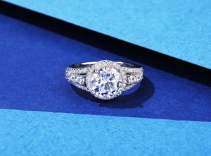 Macro view of a round 8mm halo engagement ring with split-shank micro-pave setting