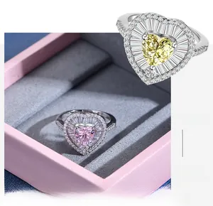Macro shot of heart-shaped yellow diamond ring with tiered halo setting in a pink box