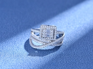 Macro shot of silver four-layer interlaced ring with micro-pave crystals and baguette center