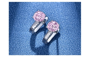 Detailed close-up of 925 silver hoop earrings featuring 4-prong set pink round gemstones