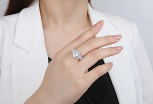 Macro detail of 925 sterling silver ring with 8mm halo round cubic zirconia on finger