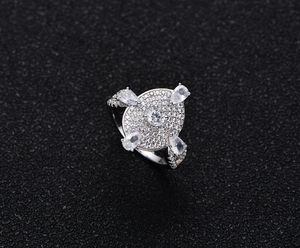 Top-down view of S925 sterling silver ring with oval pavé diamonds and pear-cut accents