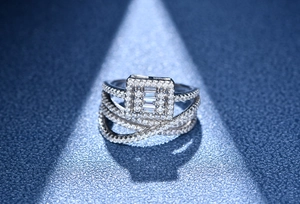 Macro view of four-layer silver ring with micro-pave diamonds and emerald-cut stones