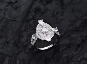 Close-up of S925 sterling silver ring with oval pavé setting and micro-inlaid stones