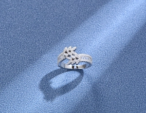 Macro shot of 925 silver leaf ring with double row diamond pavé and marquise stones