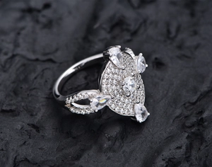 Macro detail of S925 sterling silver ring featuring pave set diamonds and pear-cut cubic zirconia