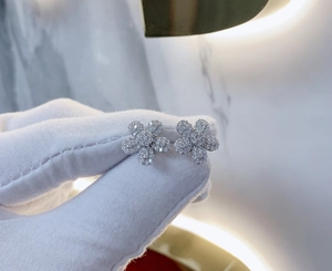 Vue détaillée des boucles d'oreilles fleurs en pavé argenté avec micro-incrustations