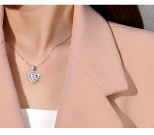 Close-up of a 925 silver necklace with heart-shaped pink stone and diamond halo