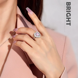 Detail of pink heart-shaped ring in 925 sterling silver with halo cubic zirconia stones