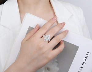 Macro detail of S925 silver oval ring with micro-pave crystals worn by a model