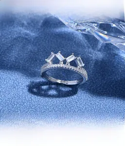 Macro detail of crown ring featuring rectangular-cut crystals and micro-pave setting