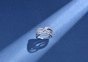 Detailed view of S925 sterling silver ring with woven zircon bands and textured shadow