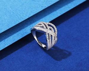 Macro detail of multi-layer wavy S925 silver ring with baguette and round cut zircon stones