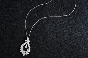 Close-up of S925 sterling silver laurel wreath necklace with a dancing teardrop pendant