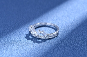 Detailed macro view of crown ring featuring baguette-cut and pavé-set zircons on silver band