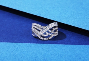 Detailed macro view of multi-layer wavy S925 silver ring with baguette cut diamonds