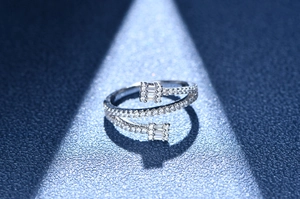 Macro view of silver triple-layered wrap ring with baguette-cut and pave diamonds