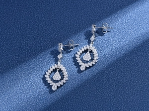 Detailed macro shot of S925 silver teardrop earrings with pave-set shimmering crystals