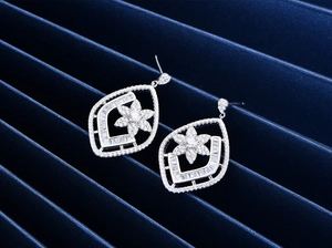 Macro detail of S925 sterling silver drop earrings with micro-set cubic zirconia flowers