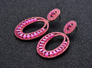 Macro shot of oval pink tourmaline earrings in rose gold setting with pavé gems