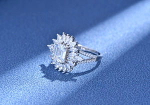 Macro shot of 925 silver ring featuring an Asscher cut center stone and floral halo