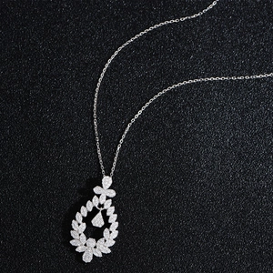 S925 sterling silver necklace featuring a sparkling wreath pendant on black background