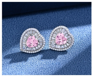 Macro shot of 925 sterling silver heart stud earrings with pink center stone and halo diamonds