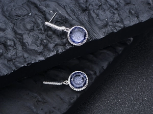 Macro view of round 11mm purple carbon diamond earrings with S925 silver setting