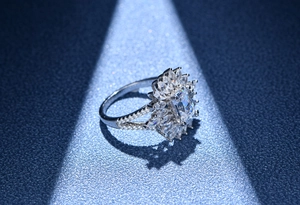 Macro shot of Asscher cut main stone and marquise diamond halo on silver band