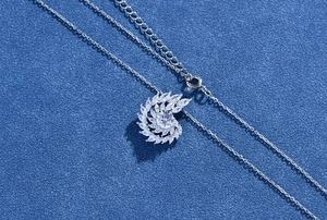 Detailed view of spiral silver necklace pendant with sparkling marquise cut cubic zirconia