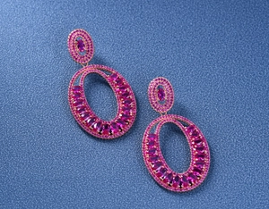 Detailed macro view of pink tourmaline oval earrings in rose gold over silver