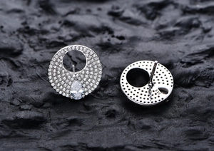 Close-up of S925 sterling silver stud earrings with pave diamonds and 925 hallmark stamp