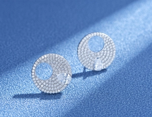 Detailed view of S925 sterling silver pave disk earrings with pear-cut yellow stones