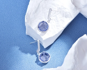 Macro shot of 11mm purple carbon diamond earrings with S925 silver setting on stone