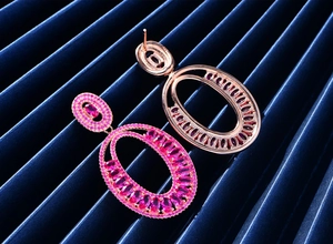 Macro view of rose gold oval drop earrings with pink tourmaline stones and hollow back
