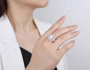Macro view of Asscher cut 925 silver ring with marquise halo on female model hand