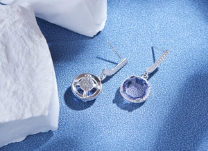Macro detail of round blue cubic zirconia earrings with s925 sterling silver halo studs