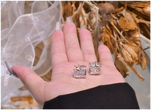 Detail view of crown square stud earrings with transparent carbon diamond in silver